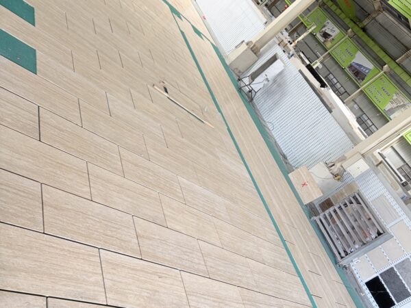 Cross-cut travertine panels arranged in a row, showing the linear movement running across each panel
