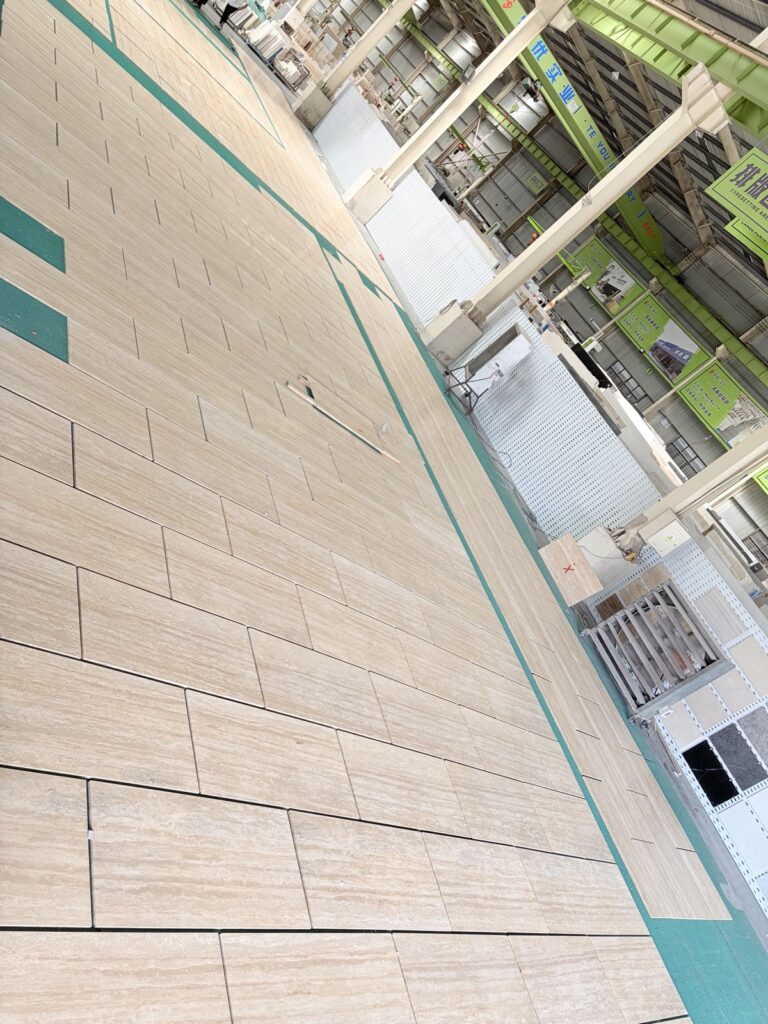 Cross-cut travertine panels arranged in a row, showing the linear movement running across each panel