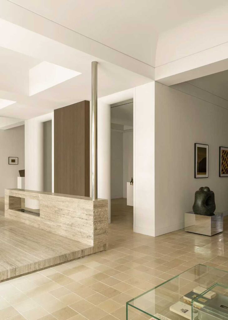 A travertine counter seen at an angle, showing the stone wrapping the end of the counter
